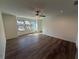 Open living room with a ceiling fan, several windows, and wood floors at 3904 Allegretto Cir # 50, Atlanta, GA 30339