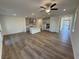 Expansive living room boasts hardwood floors, a modern kitchen island, and recessed lighting throughout at 3904 Allegretto Cir # 50, Atlanta, GA 30339