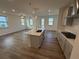 Bright living room with several windows, a ceiling fan, and plank flooring throughout at 3904 Allegretto Cir # 50, Atlanta, GA 30339