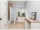 Well-lit bathroom with granite countertop, white cabinetry and shower-tub combo at 3963 Hazelhurst Lake Dr, Marietta, GA 30066