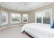 Bright bedroom featuring large windows, neutral color palette, and plush carpeting at 3963 Hazelhurst Lake Dr, Marietta, GA 30066