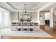 Elegant dining room with hardwood floors, wainscoting, and a stylish chandelier at 3963 Hazelhurst Lake Dr, Marietta, GA 30066