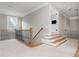 Light-filled hallway with wood and wrought iron railing and access to rooms with hardwood floors at 3963 Hazelhurst Lake Dr, Marietta, GA 30066