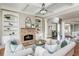 Elegant living room featuring a stone fireplace, custom built-ins, and coffered ceilings at 3963 Hazelhurst Lake Dr, Marietta, GA 30066