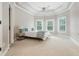 Spacious main bedroom with tray ceiling, ceiling fan and bright windows at 3963 Hazelhurst Lake Dr, Marietta, GA 30066