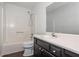 This bathroom features a shower-tub combination, modern vanity, and neutral color palette at 4162 Lake Mist Nw Dr, Kennesaw, GA 30144