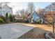 View of cozy blue home showcasing a large driveway and well-maintained front yard at 4162 Lake Mist Nw Dr, Kennesaw, GA 30144