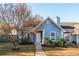 Charming blue home with trimmed landscaping, complemented by a mature tree in the front yard at 4162 Lake Mist Nw Dr, Kennesaw, GA 30144