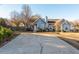 Blue home with a charming exterior view, complemented by a wide driveway and tidy landscaping at 4162 Lake Mist Nw Dr, Kennesaw, GA 30144