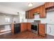 Open kitchen featuring granite countertops, stainless steel appliances, and wood cabinetry at 4162 Lake Mist Nw Dr, Kennesaw, GA 30144