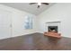 Living room with a fireplace, ceiling fan, and hardwood floors, bathed in natural light at 4162 Lake Mist Nw Dr, Kennesaw, GA 30144