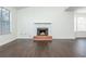 Bright living room with a brick fireplace, hardwood floors, and large windows at 4162 Lake Mist Nw Dr, Kennesaw, GA 30144