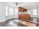 Bright living room featuring hardwood floors, a ceiling fan, and large windows for natural light at 4162 Lake Mist Nw Dr, Kennesaw, GA 30144