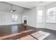 Bright living room featuring a fireplace, hardwood floors, and large windows for natural light at 4162 Lake Mist Nw Dr, Kennesaw, GA 30144