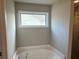 Bathroom features a soaking tub and a bright window at 4421 Fulson Dr, Lilburn, GA 30047