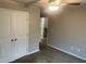 Bright bedroom with carpet flooring, a ceiling fan, and closet doors for storage at 4421 Fulson Dr, Lilburn, GA 30047