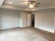 Primary bedroom featuring a ceiling fan and neutral carpet at 4421 Fulson Dr, Lilburn, GA 30047