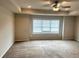 Primary bedroom with neutral carpet and a large window at 4421 Fulson Dr, Lilburn, GA 30047