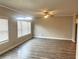 Open-concept living area with hardwood floors and modern light fixtures at 4421 Fulson Dr, Lilburn, GA 30047