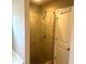 Walk-in shower with glass door and tiled walls at 4421 Fulson Dr, Lilburn, GA 30047