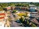 Aerial view of a mixed-use commercial area with brick buildings, parking, green space and tree lined streets at 5005 Crestline View Rd, Cumming, GA 30028