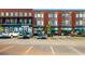 View of two story retail stores featuring a brick facade, multiple shops and offices, and ample parking at 5005 Crestline View Rd, Cumming, GA 30028