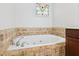 Close up view of a jetted soaking tub with surrounding tile work at 556 Moreland Ne Ave # J, Atlanta, GA 30307