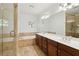 Bathroom with double vanity, tiled floors, soaking tub, and glass shower at 556 Moreland Ne Ave # J, Atlanta, GA 30307