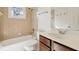 Bathroom featuring a tub/shower combo, cherry vanity, and tile at 556 Moreland Ne Ave # J, Atlanta, GA 30307