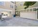 View of two-car garage, driveway, and green space at 556 Moreland Ne Ave # J, Atlanta, GA 30307