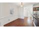 Hallway with hardwood floors, wainscoting, crown molding, and modern light fixtures at 556 Moreland Ne Ave # J, Atlanta, GA 30307