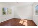 Bright room featuring hardwood floors, wainscoting, and natural light from two large windows at 556 Moreland Ne Ave # J, Atlanta, GA 30307