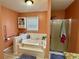 Bright bathroom features a built-in tub, shower, window for natural light, and a tiled floor at 1536 Hunters Cv, Auburn, GA 30011