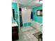 Bright bathroom featuring a bathtub and shower combination, tiled floors, and storage at 1536 Hunters Cv, Auburn, GA 30011