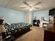 Bedroom with a full size bed, shelving unit, vanity, and blue walls at 1536 Hunters Cv, Auburn, GA 30011