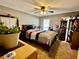 Bedroom featuring a ceiling fan, neutral walls, carpet, and side tables at 1536 Hunters Cv, Auburn, GA 30011