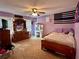 Spacious bedroom with large windows for natural light, ceiling fan, and wall decor at 1536 Hunters Cv, Auburn, GA 30011