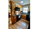 Well-equipped kitchen featuring black appliances, wood cabinets and tiled backsplash at 1536 Hunters Cv, Auburn, GA 30011