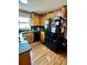 Kitchen featuring modern black appliances, wood cabinets, granite countertops and convenient breakfast bar at 1536 Hunters Cv, Auburn, GA 30011