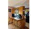 Kitchen featuring bar counter with stools, black appliances and stylish backsplash at 1536 Hunters Cv, Auburn, GA 30011