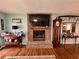 A cozy living room enhanced by a brick fireplace and filled with Gathering photos at 1536 Hunters Cv, Auburn, GA 30011