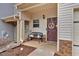 Inviting front porch with a cozy bench and decorative wreath on the front door at 553 Oakside Pl, Acworth, GA 30102