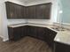 Well-appointed kitchen features granite countertops, stainless steel sink, and wood flooring at 680 Sundial Ln, Mableton, GA 30126