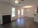 Bright open living room with fireplace, wood flooring, and large windows at 680 Sundial Ln, Mableton, GA 30126