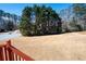 View of the spacious backyard, lined with lush trees, from the outdoor deck at 811 Weeping Willow Dr, Powder Springs, GA 30127