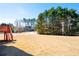 Expansive lawn backyard with mature trees and the deck and stairs on the left side at 811 Weeping Willow Dr, Powder Springs, GA 30127