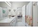 Bright bathroom with a large vanity providing ample storage and decorative floral shower curtain at 811 Weeping Willow Dr, Powder Springs, GA 30127
