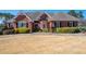 Beautiful, single-story brick home featuring manicured landscaping and a well-maintained lawn at 811 Weeping Willow Dr, Powder Springs, GA 30127
