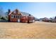 Wide angle exterior shot of the house with a large lawn and a wooden deck at 811 Weeping Willow Dr, Powder Springs, GA 30127