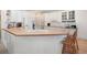 Bright kitchen features white cabinetry, a light countertop, and a sink below the window at 811 Weeping Willow Dr, Powder Springs, GA 30127